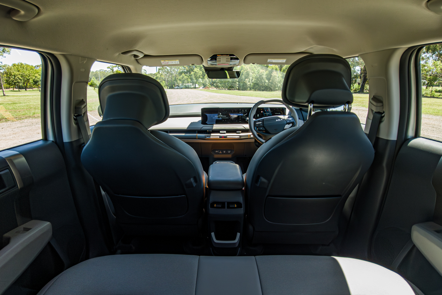 Interior of the 2026 Kia EV3 Earth Long Range looking forward from the rear seat to the dashboard