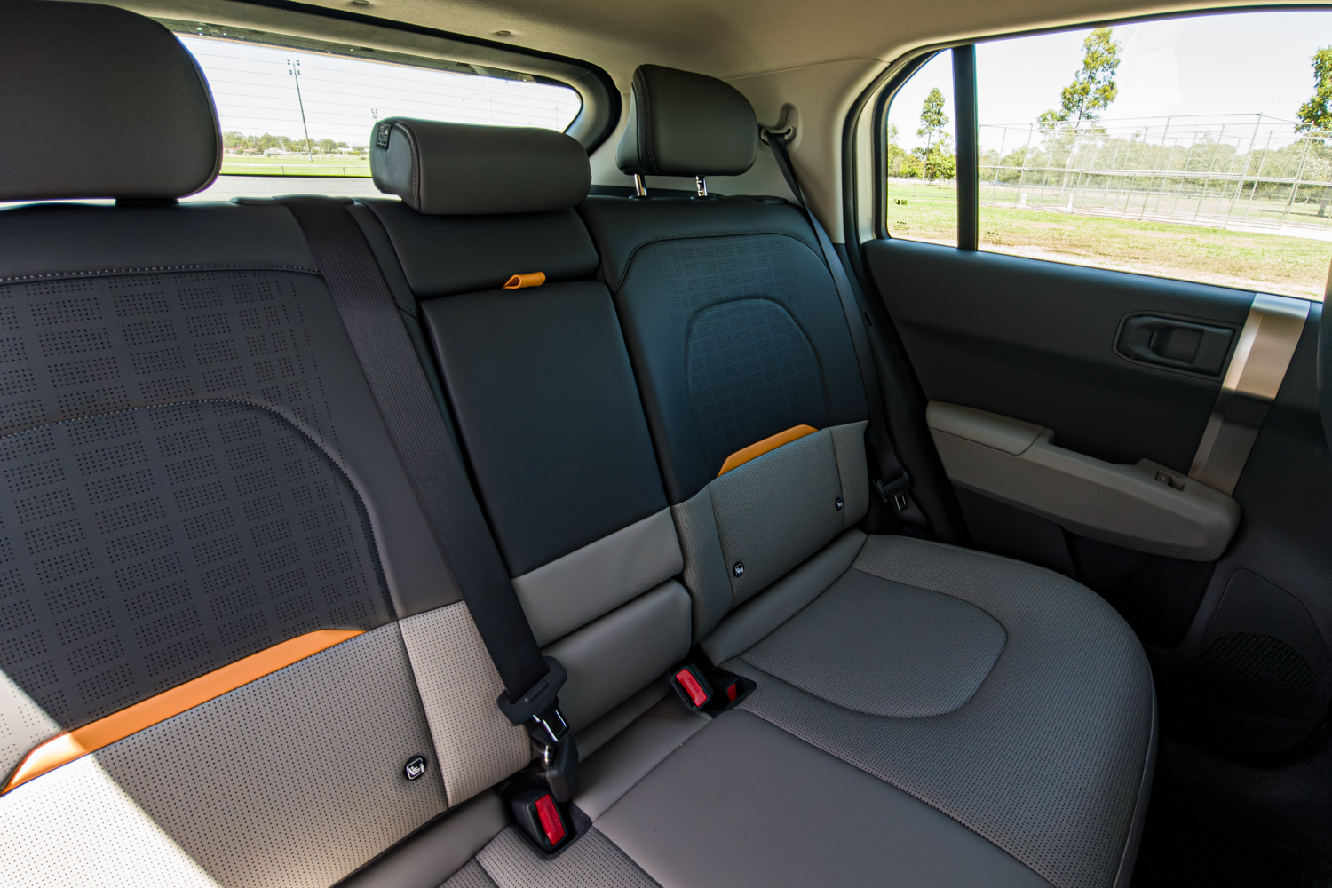 Rear seats of the 2026 Kia EV3 Earth Long Range viewed through the driver's-side door