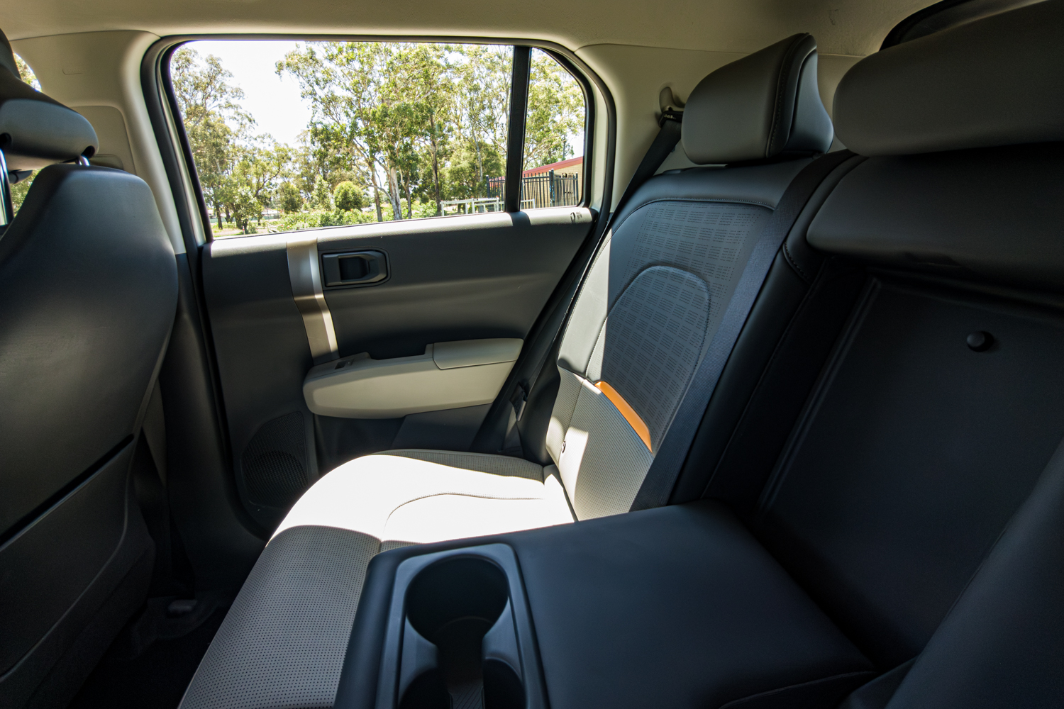 Rear seats of the 2026 Kia EV3 Earth Long Range viewed from the passenger side with centre armrest