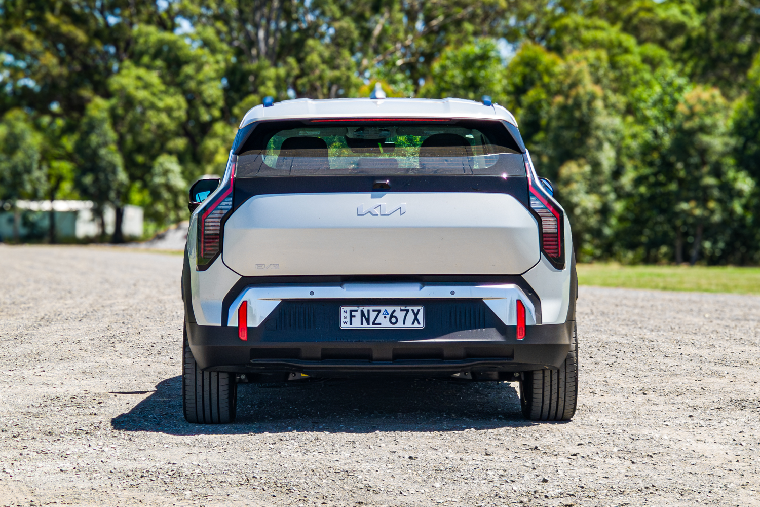 Straight-on rear view of the silver 2026 Kia EV3 Earth Long Range electric SUV