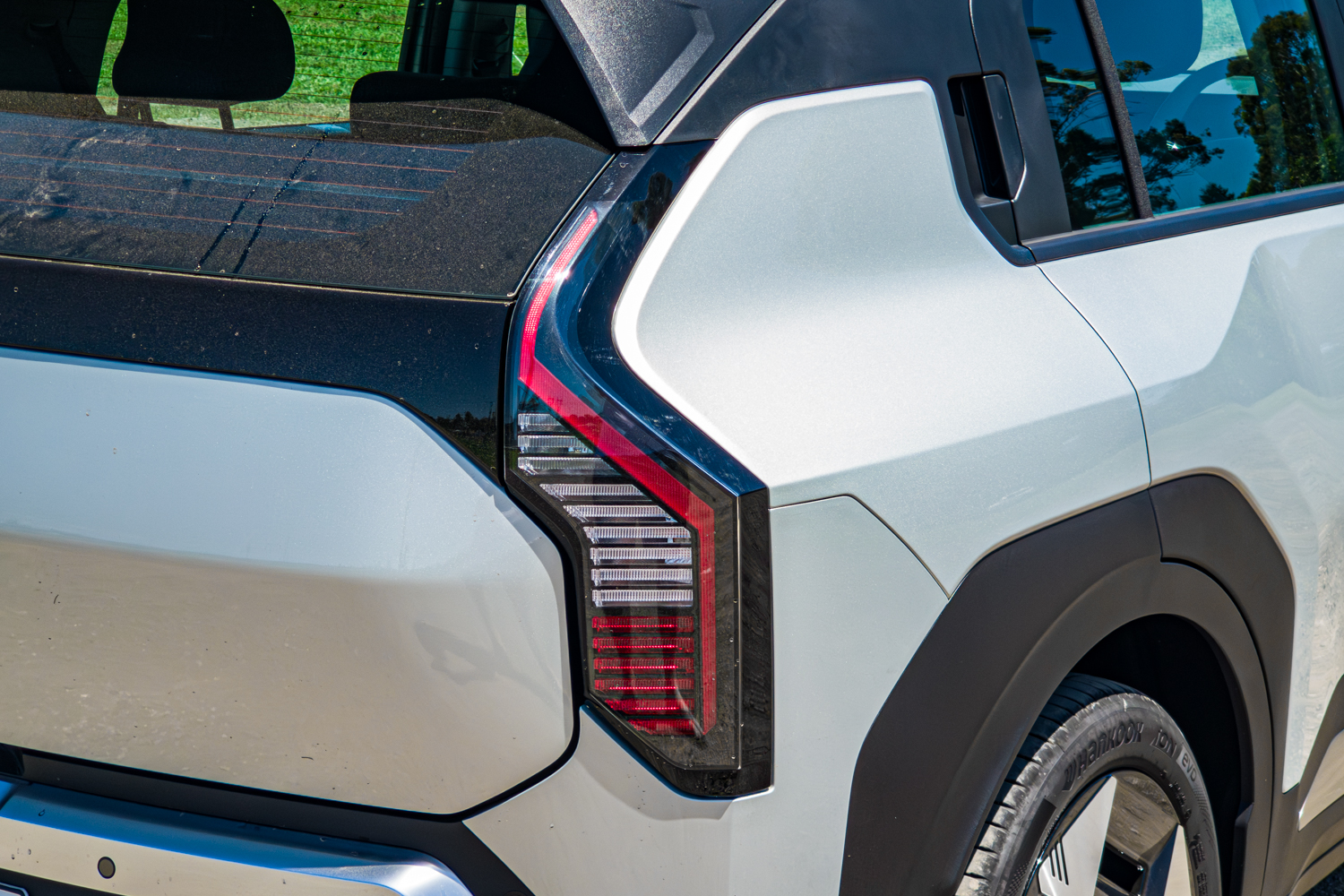 Close-up of the vertical LED tail-light on the silver 2026 Kia EV3 Earth Long Range