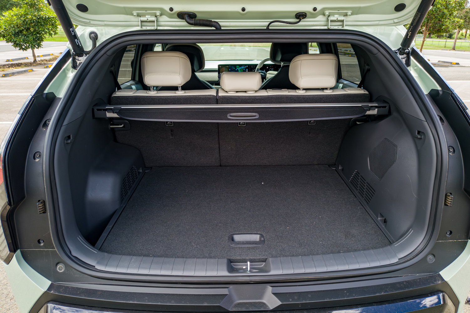 Boot interior of the 2026 Kia EV3 GT-Line with cargo cover and carpeted floor