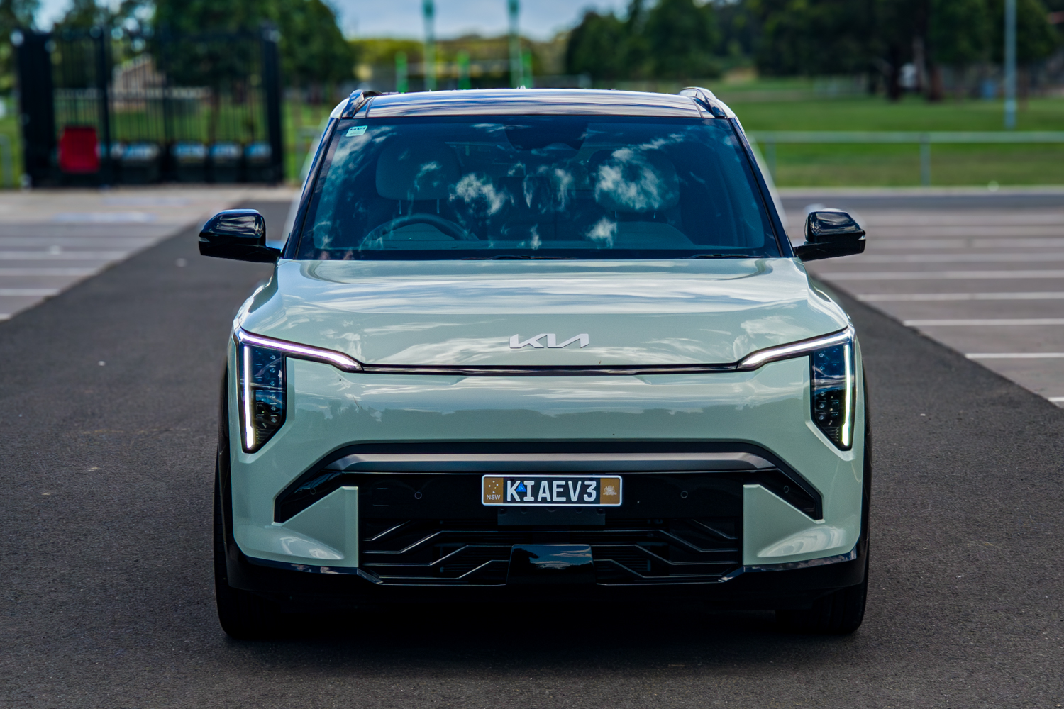 Close front view of the 2026 Kia EV3 GT-Line at a park setting