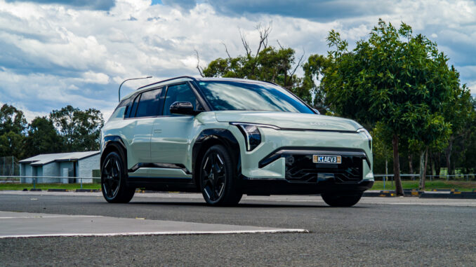Low-angle front-left three-quarter view of the 2026 Kia EV3 GT-Line in Matcha Green