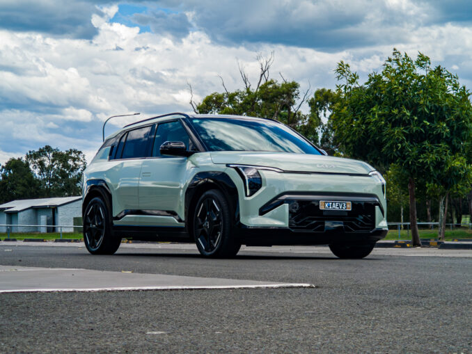 Low-angle front-left three-quarter view of the 2026 Kia EV3 GT-Line in Matcha Green