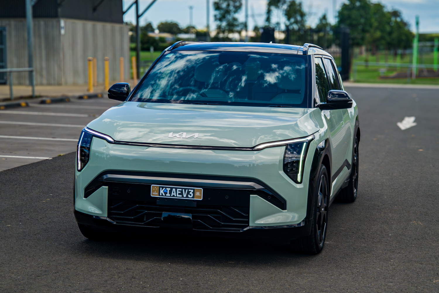Front straight-on view of the 2026 Kia EV3 GT-Line near industrial facility