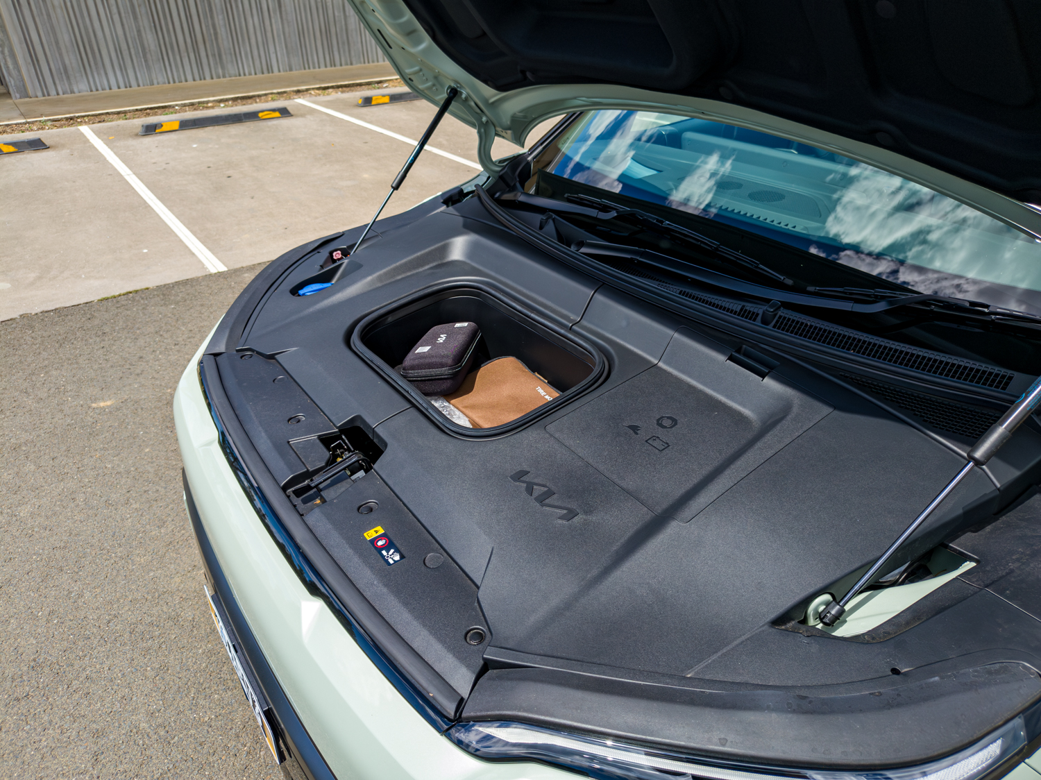 Open frunk of the 2026 Kia EV3 GT-Line showing front storage compartment