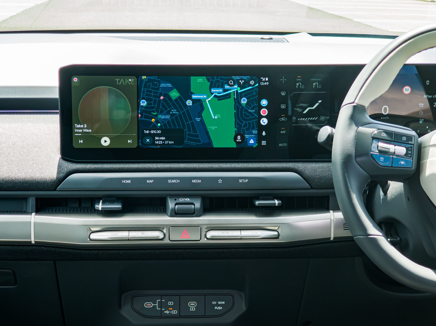 Close-up of the 2026 Kia EV3 GT-Line infotainment showing split navigation and media
