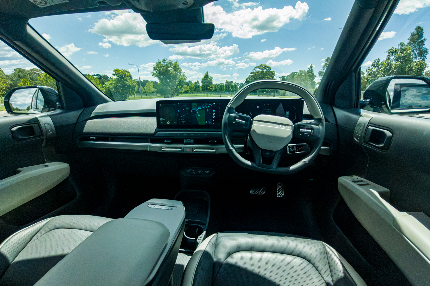 Wide interior cabin shot of the 2026 Kia EV3 GT-Line showing full dashboard and sunroof