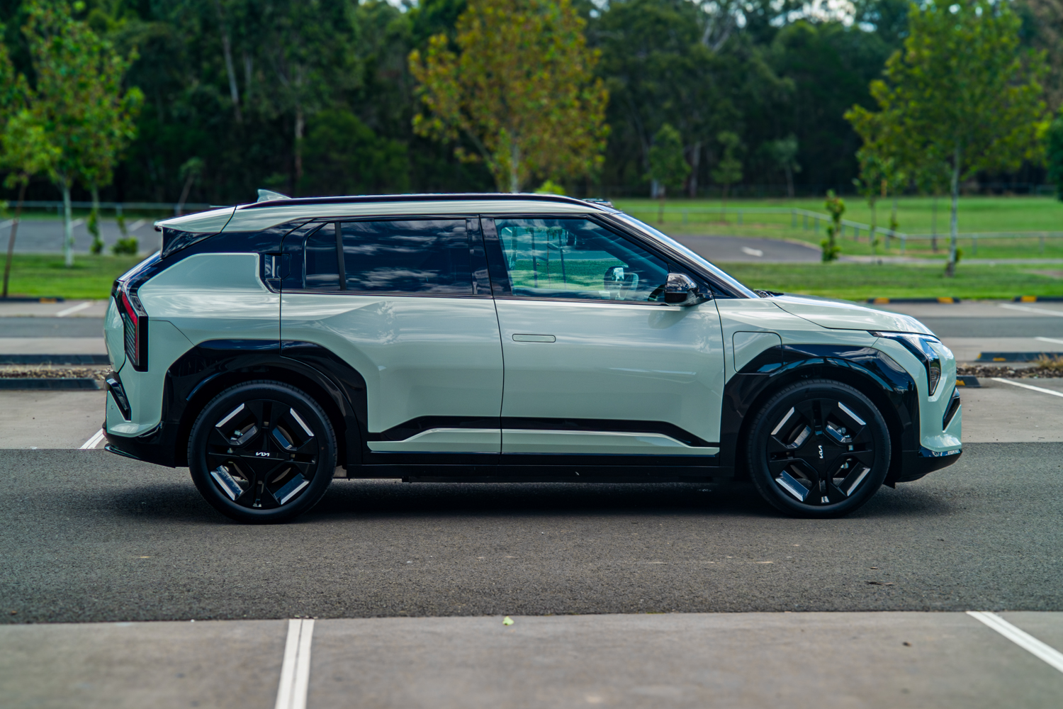 Full left side profile of the 2026 Kia EV3 GT-Line in Matcha Green