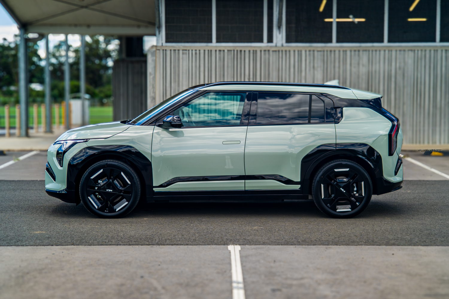 Full right side profile of the 2026 Kia EV3 GT-Line in a parking bay