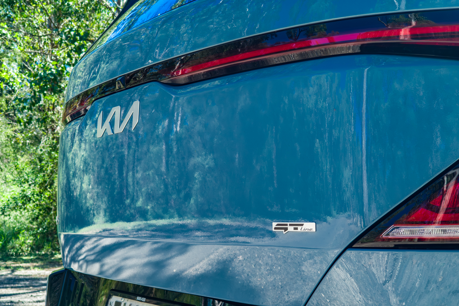 Close-up of the blue Kia EV5 GT-Line tailgate showing the Kia logo and GT-Line badge