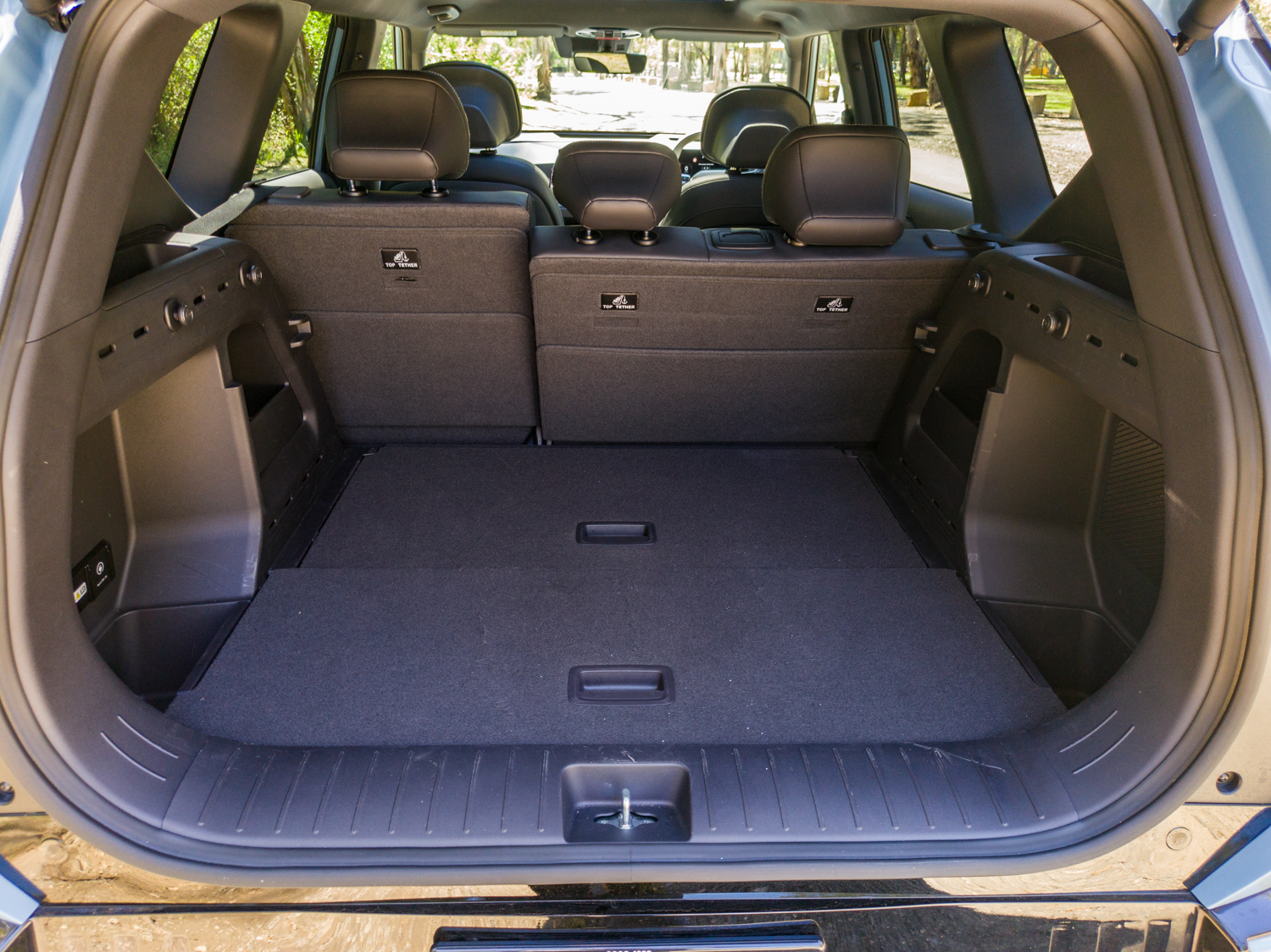 Open boot of the Kia EV5 GT-Line with the rear seats upright showing 513 litres of cargo space