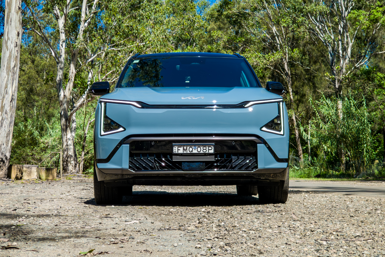 Low-angle front view of the blue Kia EV5 GT-Line electric SUV
