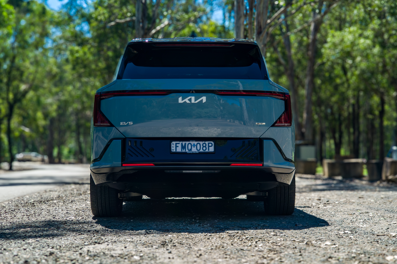 Head-on rear view of the blue Kia EV5 GT-Line showing the EV5 badge and light bar
