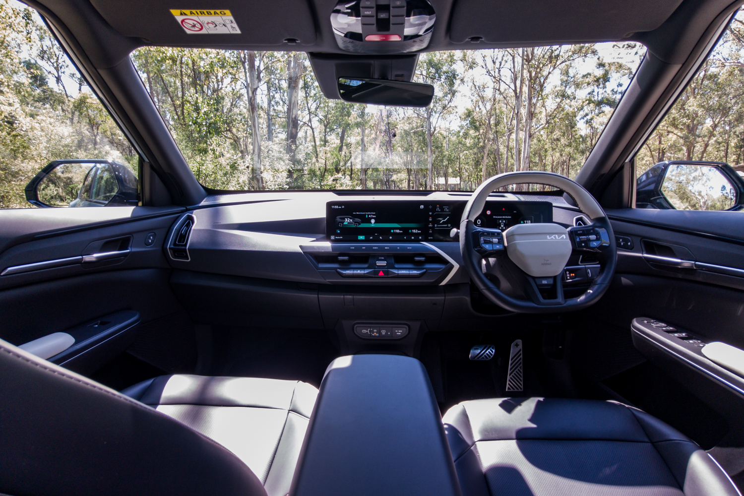 Wide interior view of the Kia EV5 GT-Line cabin, dashboard and front seats