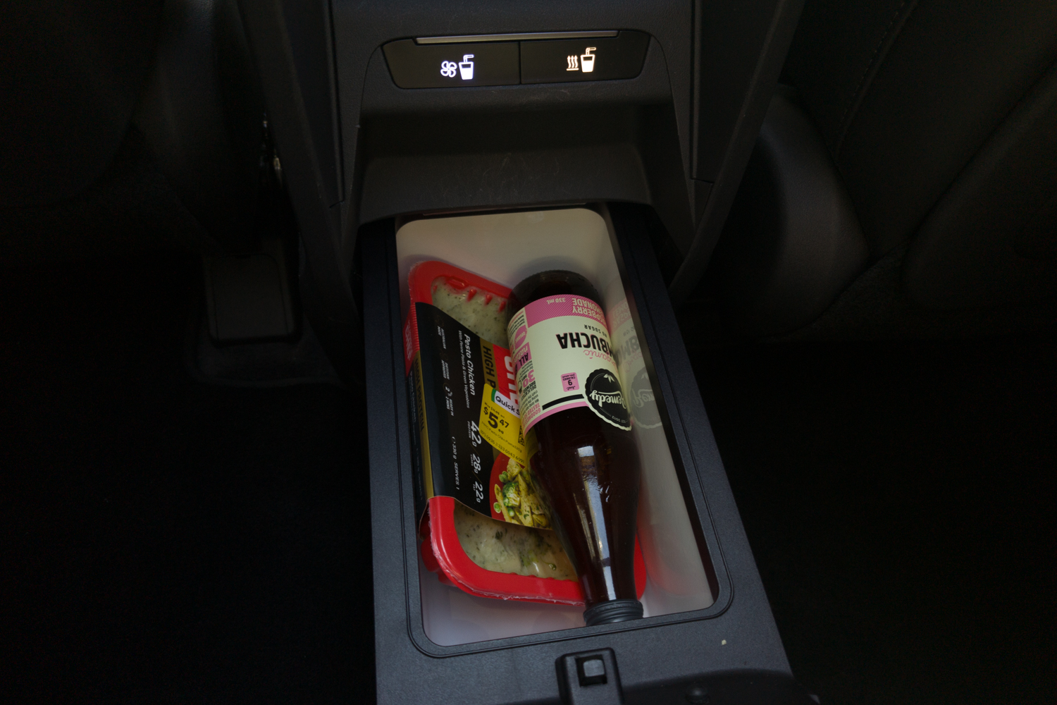 Kia EV5 GT-Line cooled console box holding a drink bottle and food container