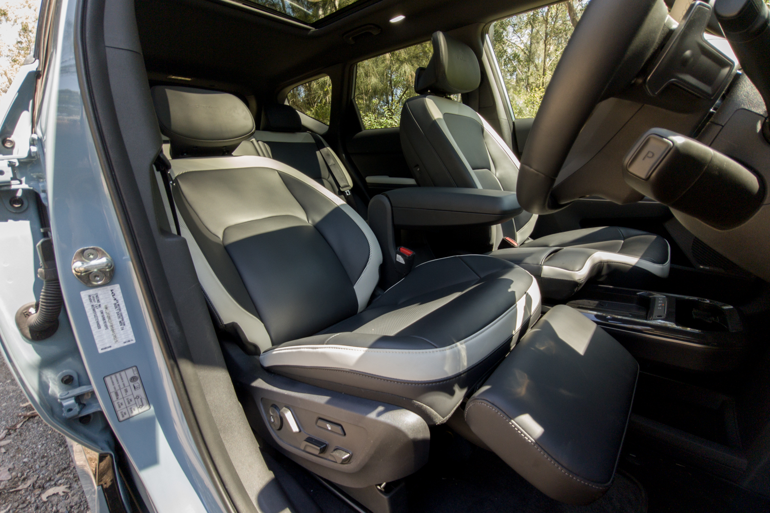 Two-tone front seats of the Kia EV5 GT-Line viewed through the passenger door