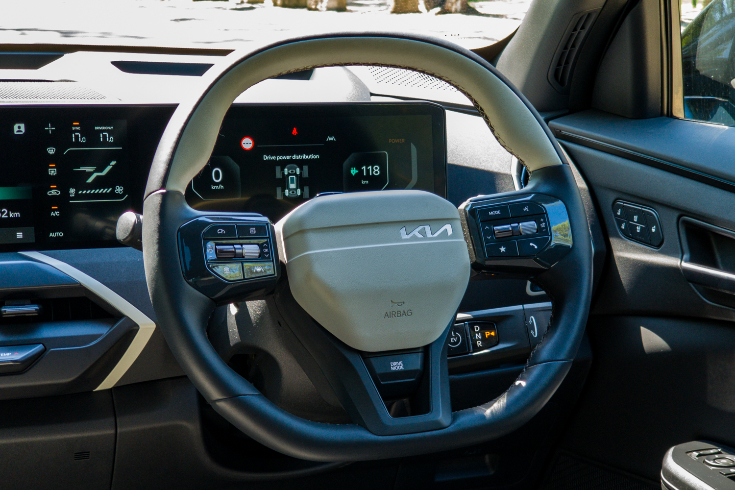 Kia EV5 GT-Line steering wheel with the digital driver display showing drive power distribution