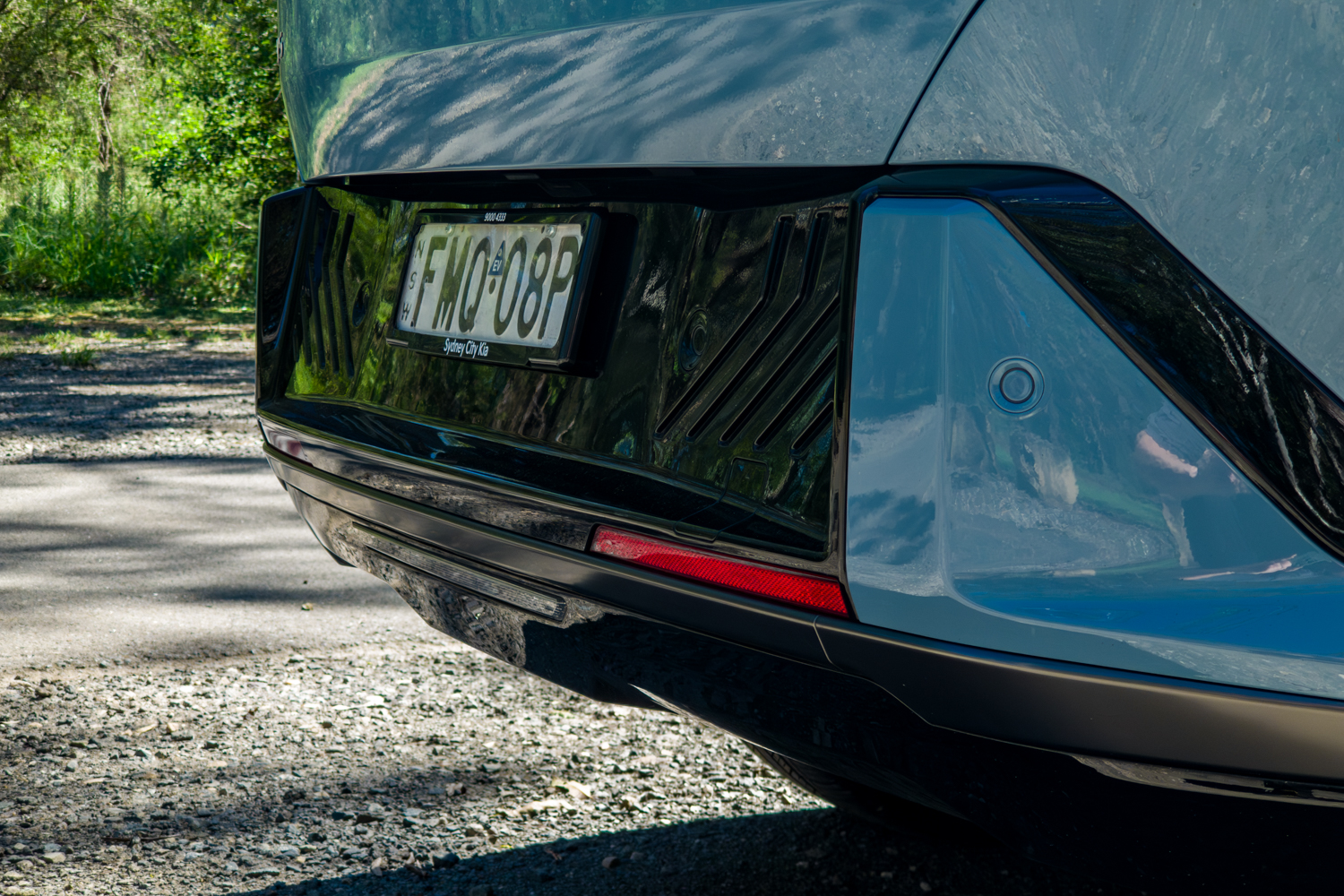 Rear bumper and number plate recess detail of the blue Kia EV5 GT-Line