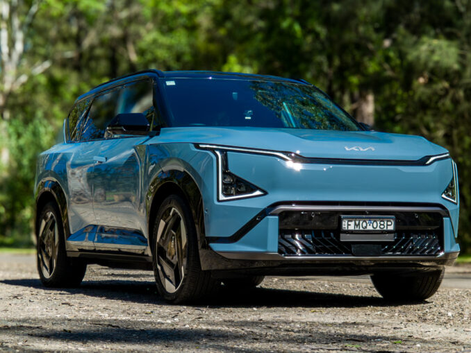 Wide low front three-quarter of the blue Kia EV5 GT-Line showing its stance