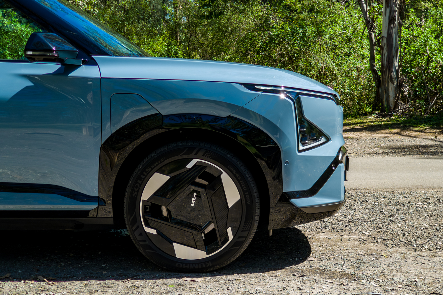 Close-up of the Kia EV5 GT-Line 20-inch alloy wheel and gloss-black arch