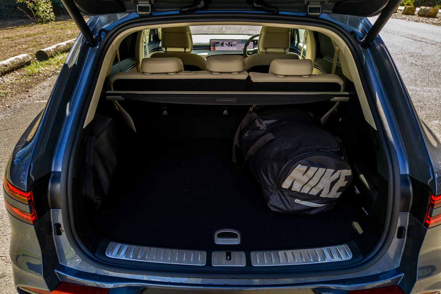 Open boot of the 2026 Genesis GV70 2.5T Advanced with a gym bag loaded on the flat cargo floor