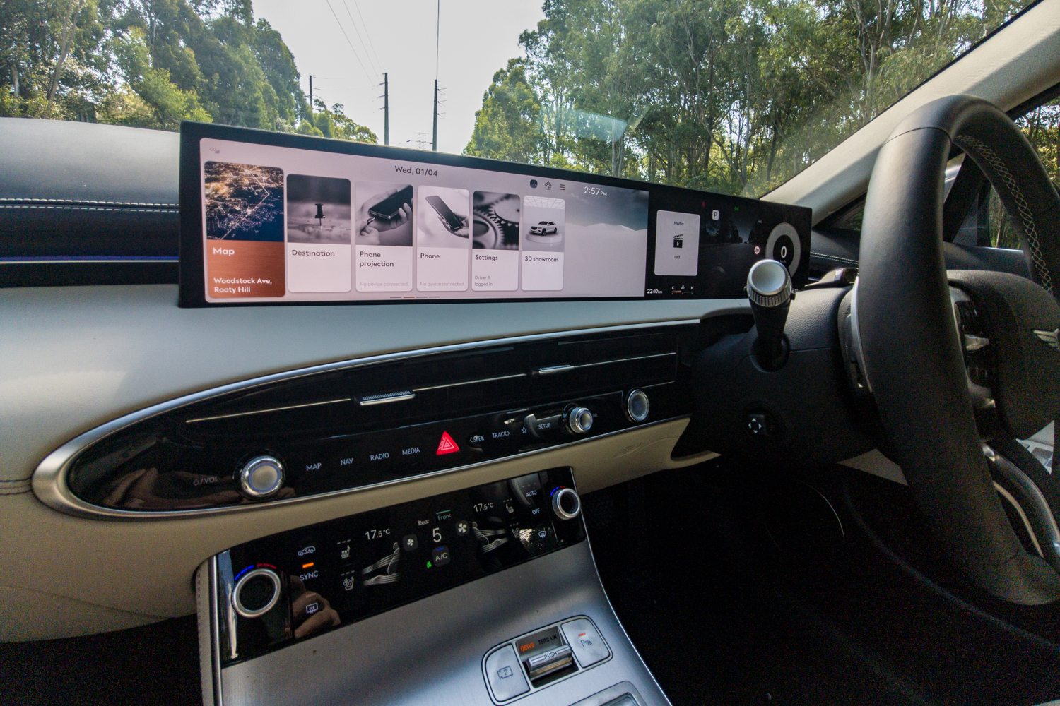 Wide-angle dashboard view of the 2026 Genesis GV70 2.5T Advanced showing the 27-inch OLED display and climate panel
