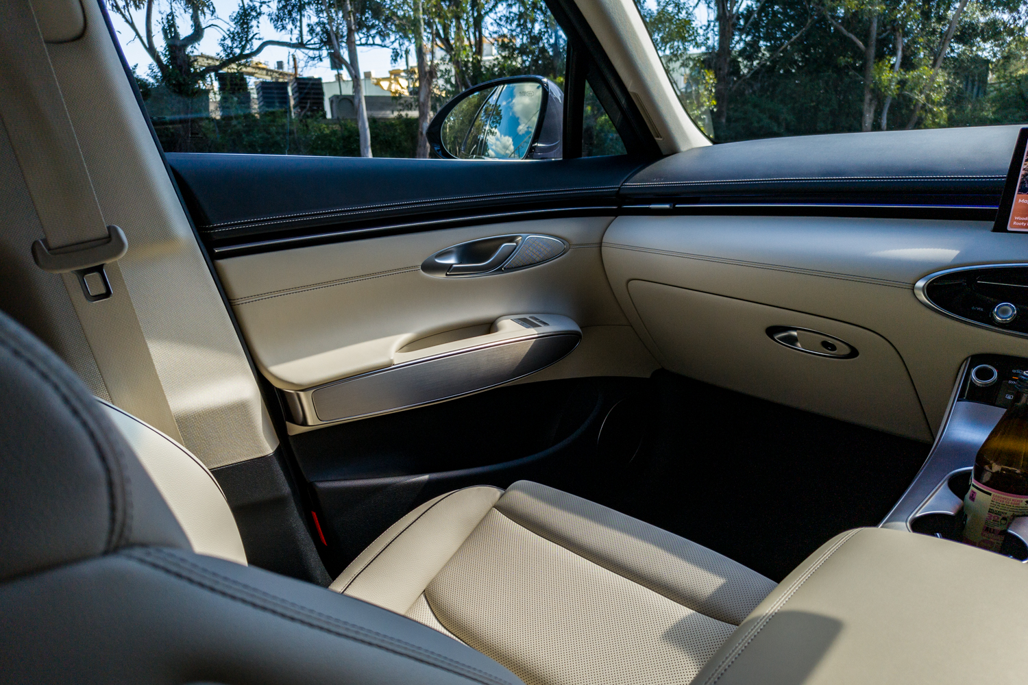 Front passenger seat and door of the 2026 Genesis GV70 2.5T Advanced in perforated cream leather