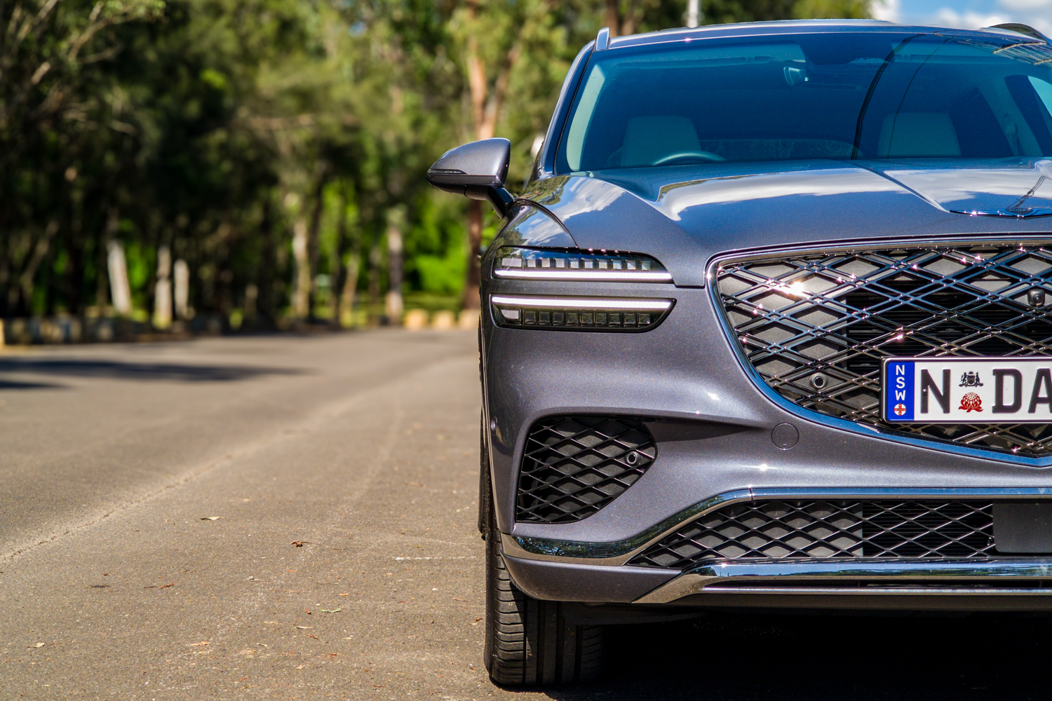 Close-up of the 2026 Genesis GV70 2.5T Advanced two-line Micro Lens Array headlight and grille edge