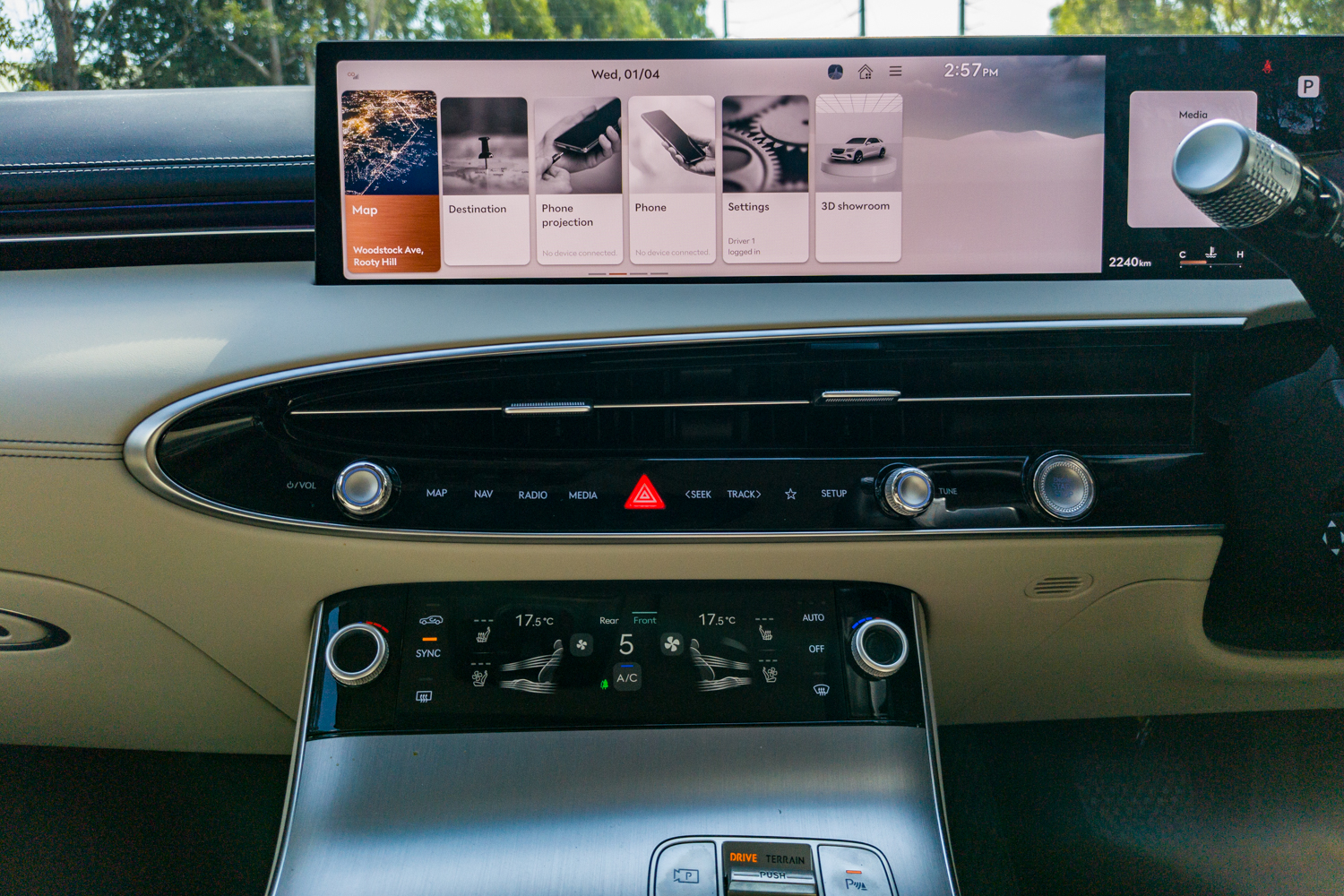 2026 Genesis GV70 2.5T Advanced 27-inch OLED home screen above the physical button bar and haptic climate panel