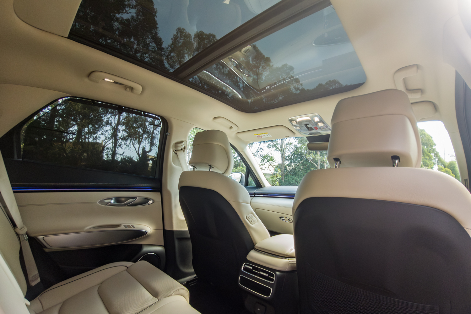 Panoramic sunroof of the 2026 Genesis GV70 2.5T Advanced seen from the rear seat with the cream headlining