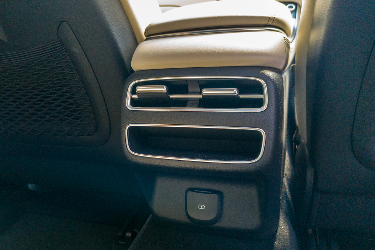 Rear console of the 2026 Genesis GV70 2.5T Advanced showing the chrome air vents and USB-C charging port