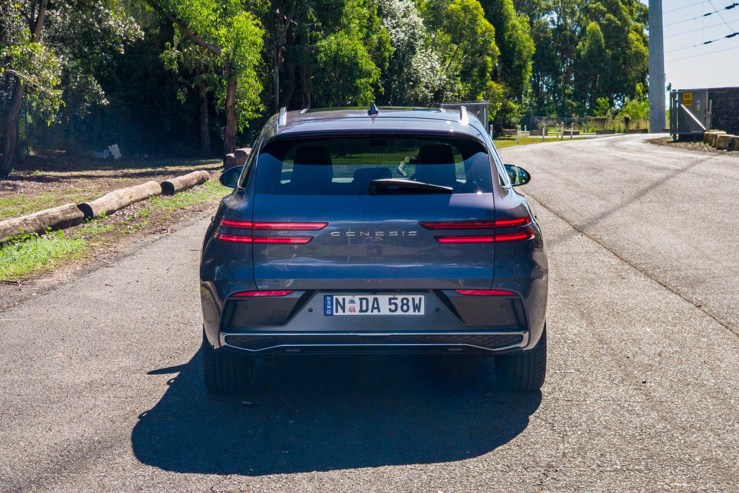 Straight-on rear view of the 2026 Genesis GV70 2.5T Advanced showing the GENESIS lettering and two-line tail lights