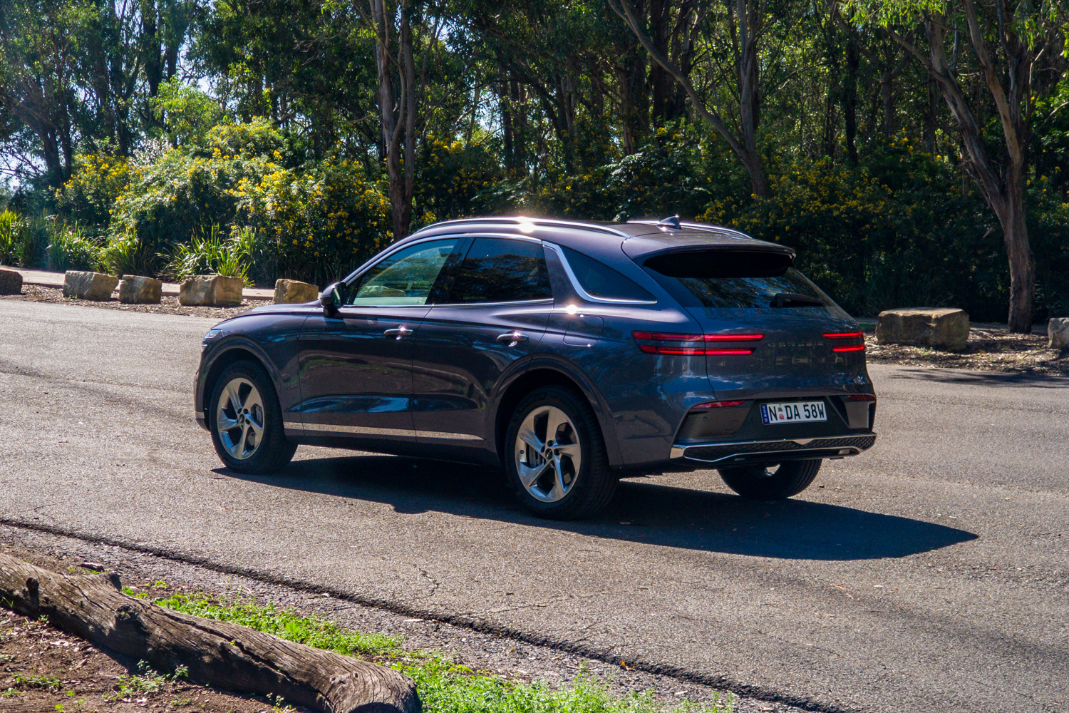 Passenger's-side rear three-quarter of the 2026 Genesis GV70 2.5T Advanced in a bushland car park