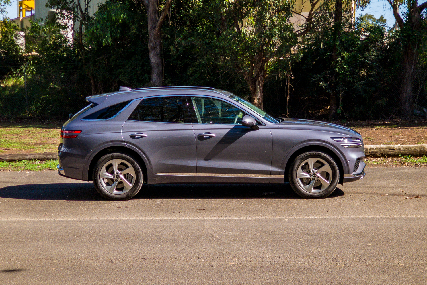 Driver's-side profile of the 2026 Genesis GV70 2.5T Advanced showing the coupe-like roofline and 19-inch wheels