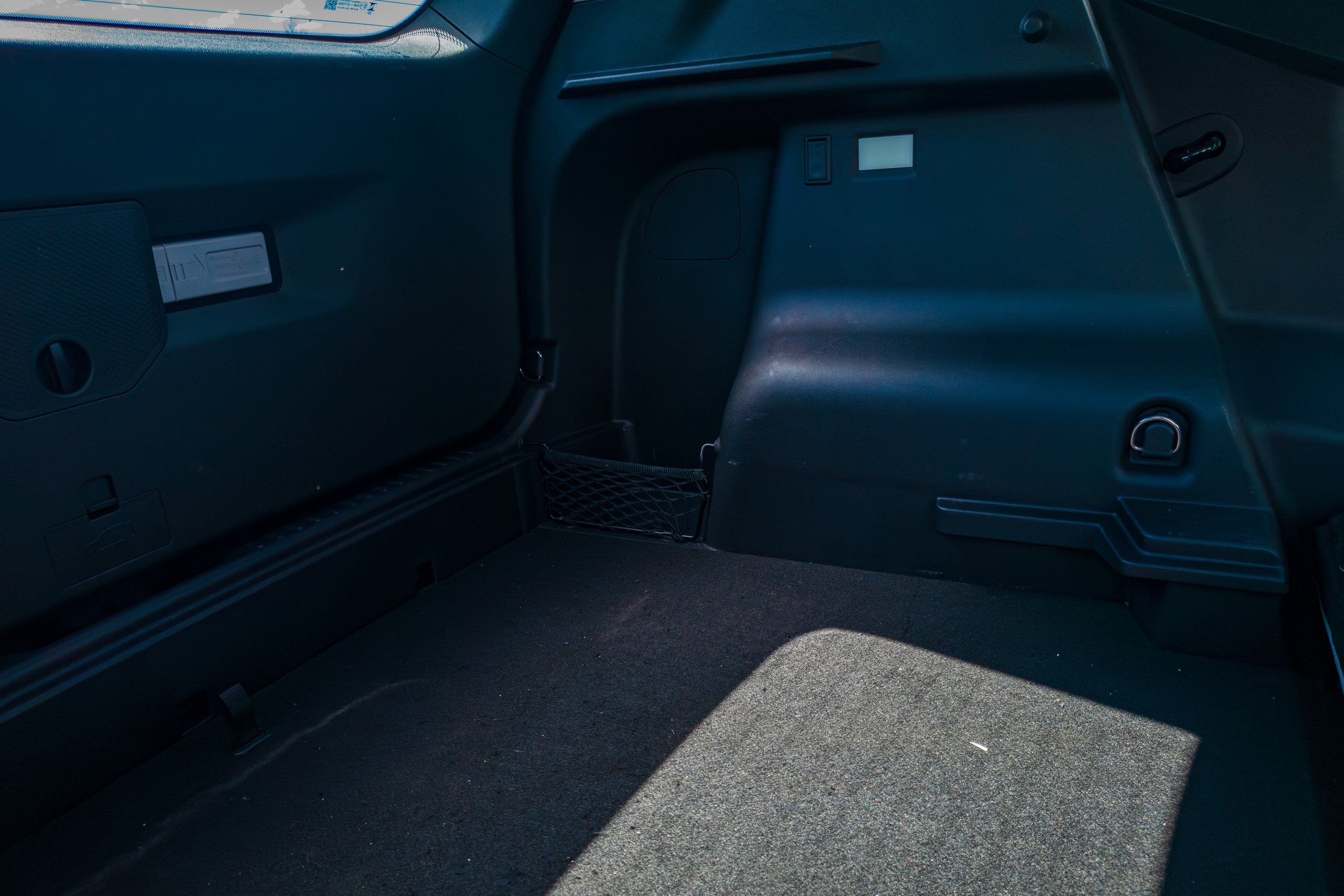 Boot side wall of the 2026 Jaecoo J5 EV Summit showing the storage net, tie-down hook and boot light
