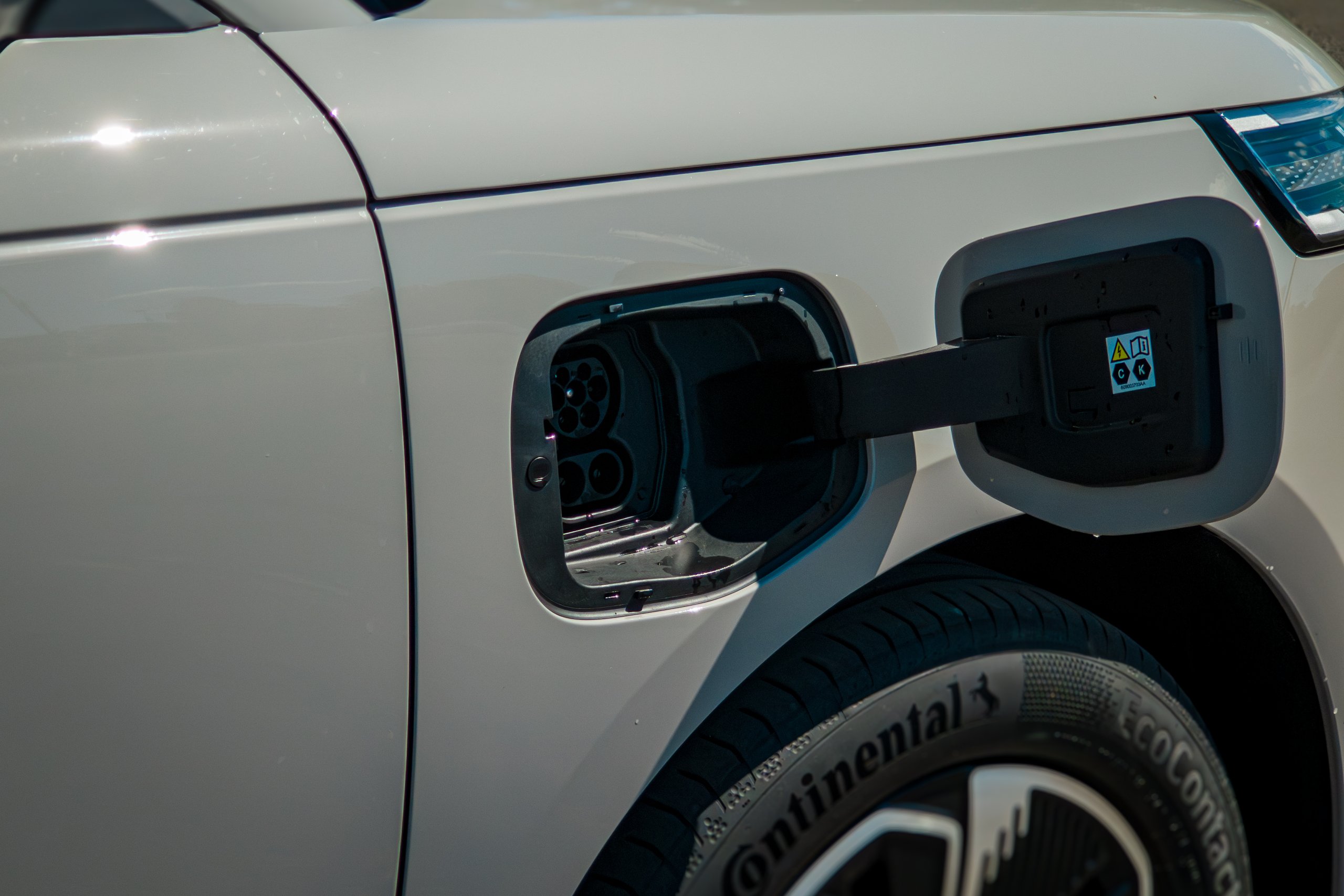 Charging flap open on the front guard of the Stone Grey 2026 Jaecoo J5 EV Summit showing the CCS2 socket