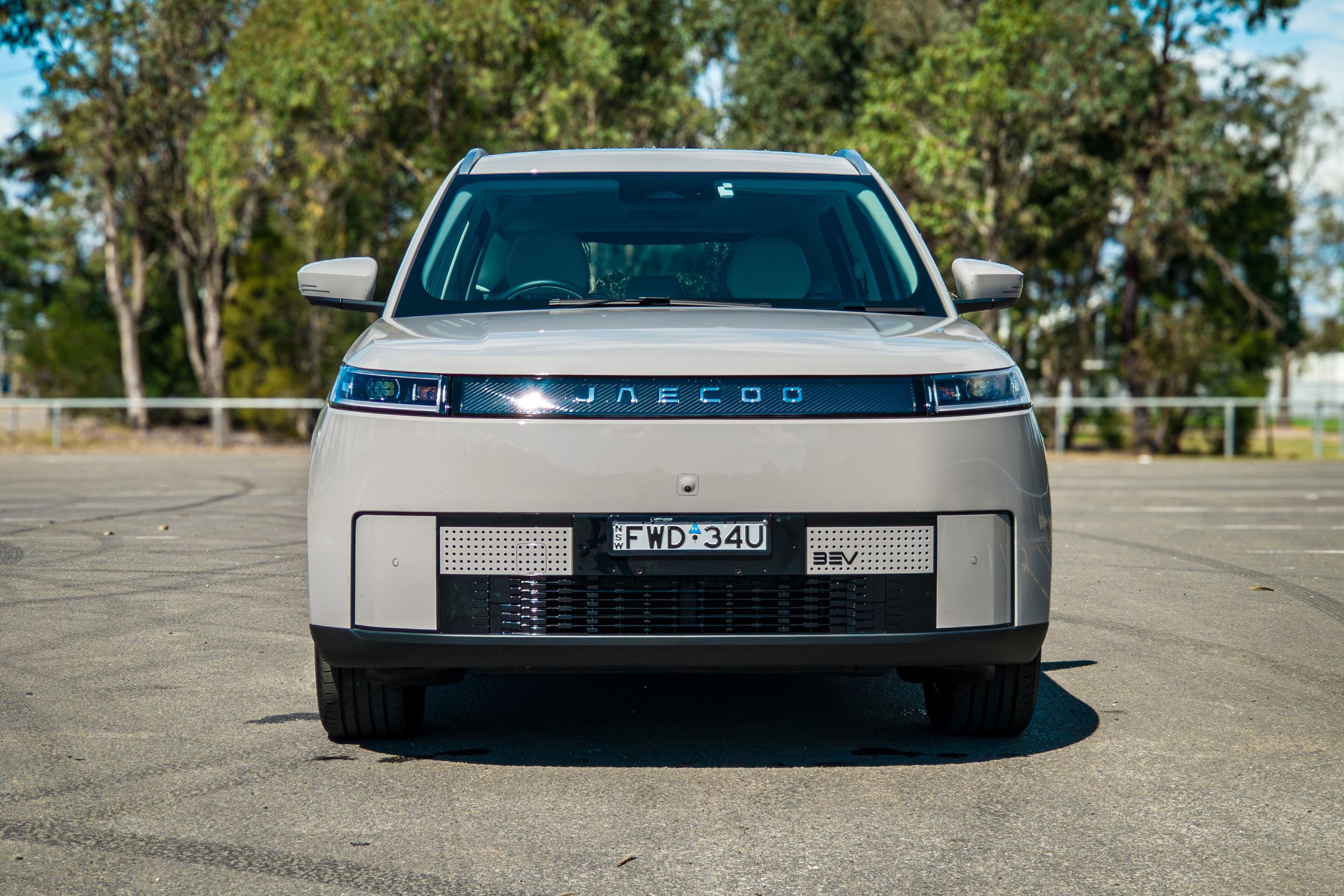 Tight straight-on front view of the Stone Grey 2026 Jaecoo J5 EV Summit showing the light bar and bumper