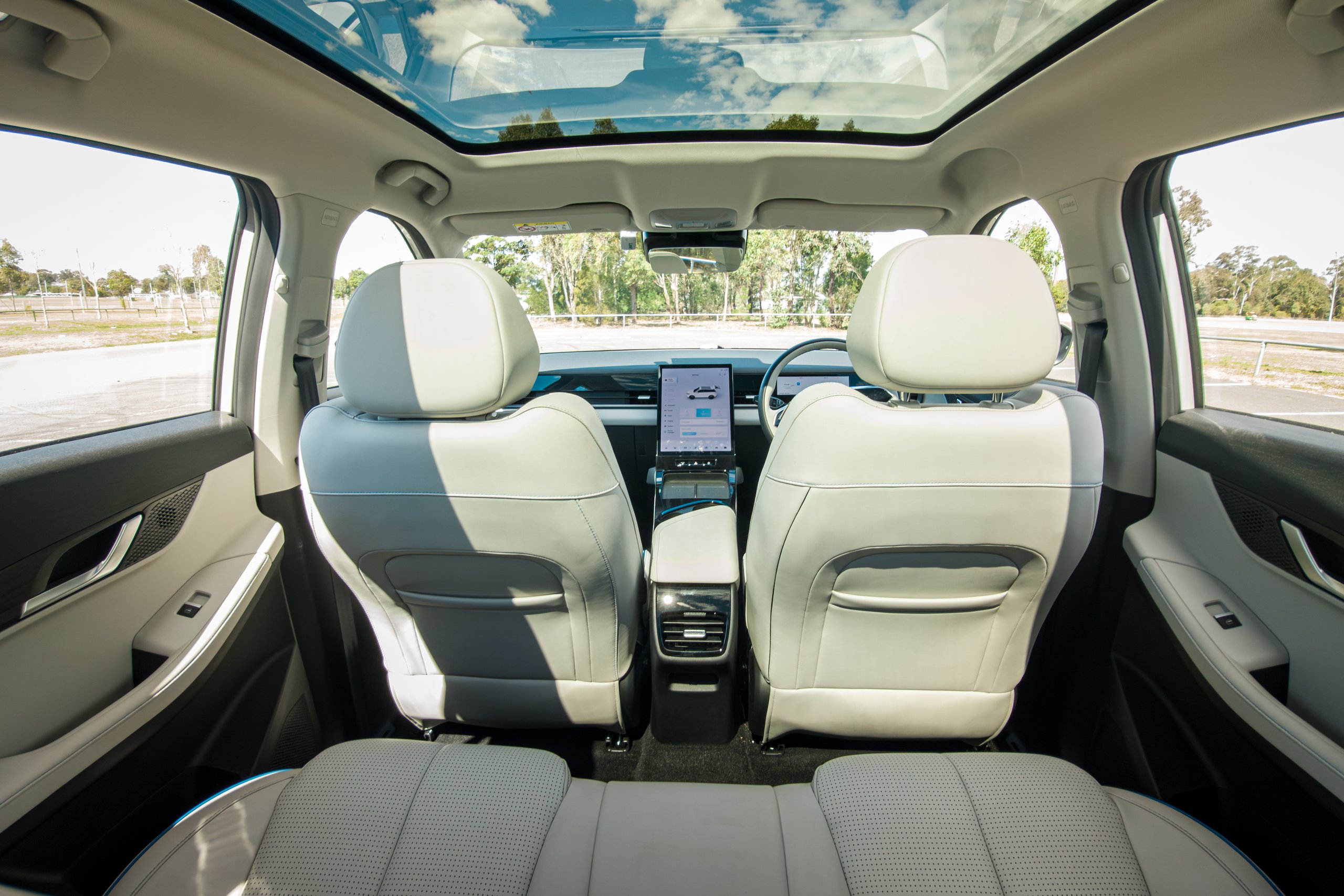 View forward from the rear seat of the 2026 Jaecoo J5 EV Summit showing the front seatbacks, centre screen and glass roof
