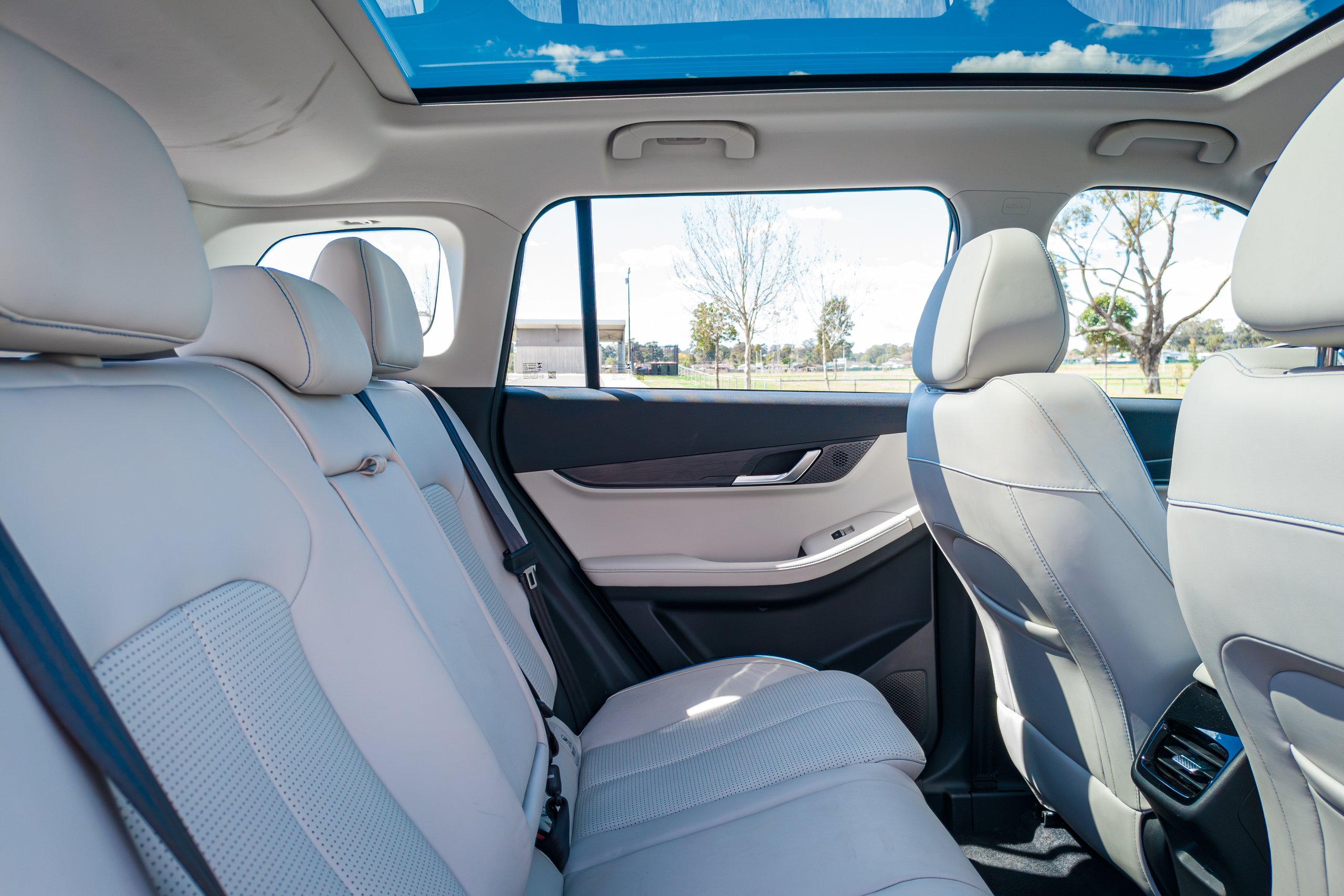 Rear seats of the 2026 Jaecoo J5 EV Summit with the panoramic glass roof visible above
