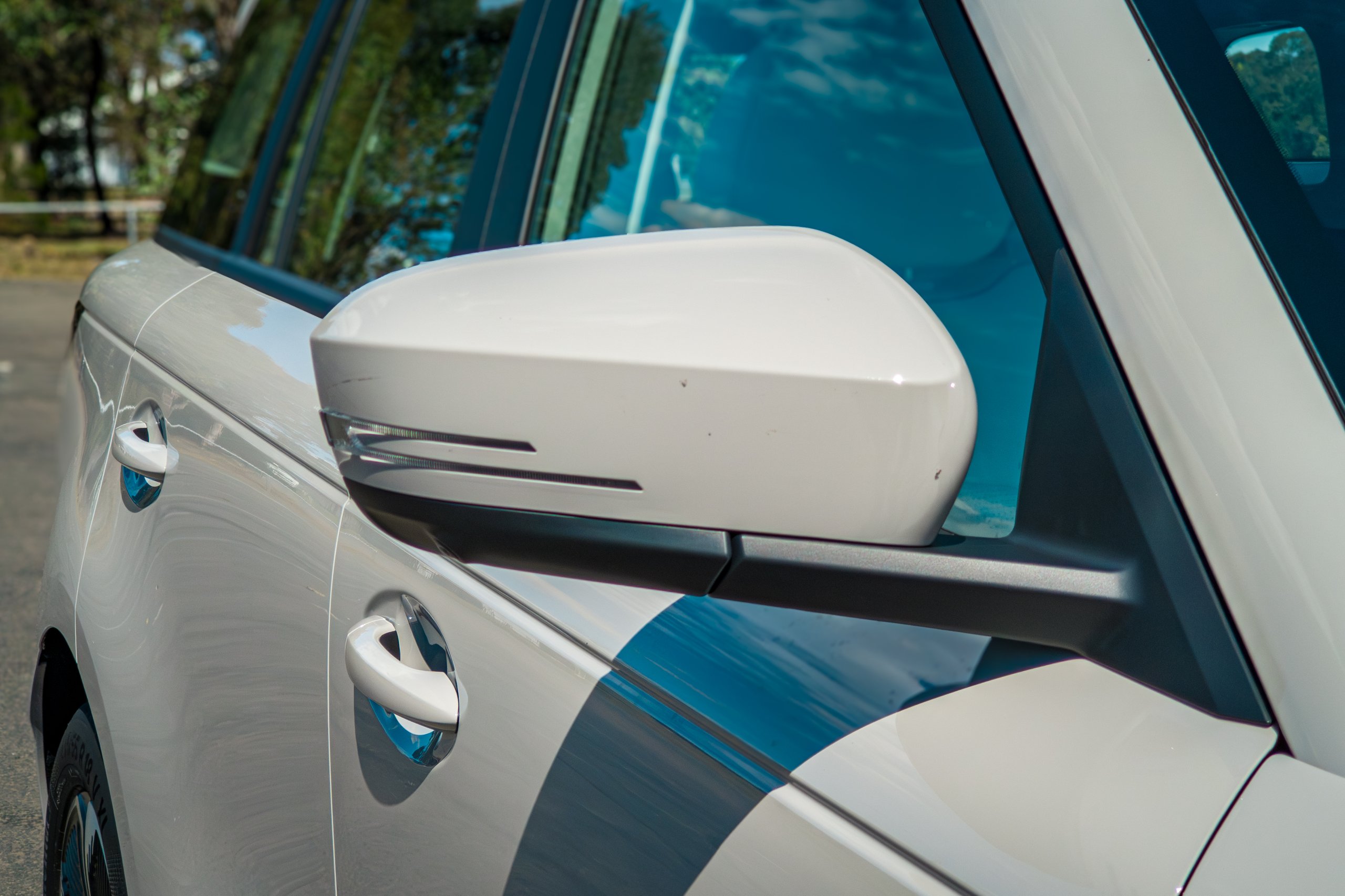 Driver-side wing mirror on the Stone Grey 2026 Jaecoo J5 EV Summit with the pop-out door handle behind