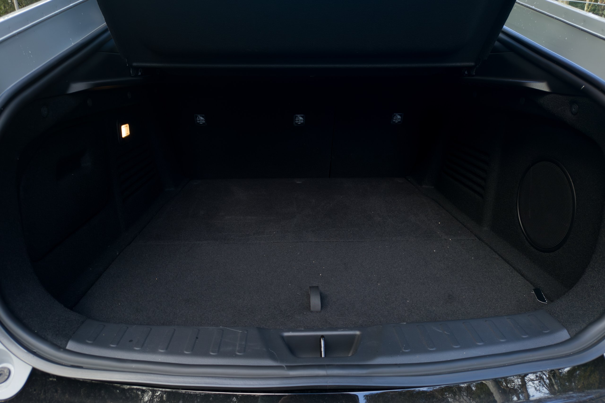 Open boot of the 2026 Mazda 6e GT showing the carpeted load area and boot light