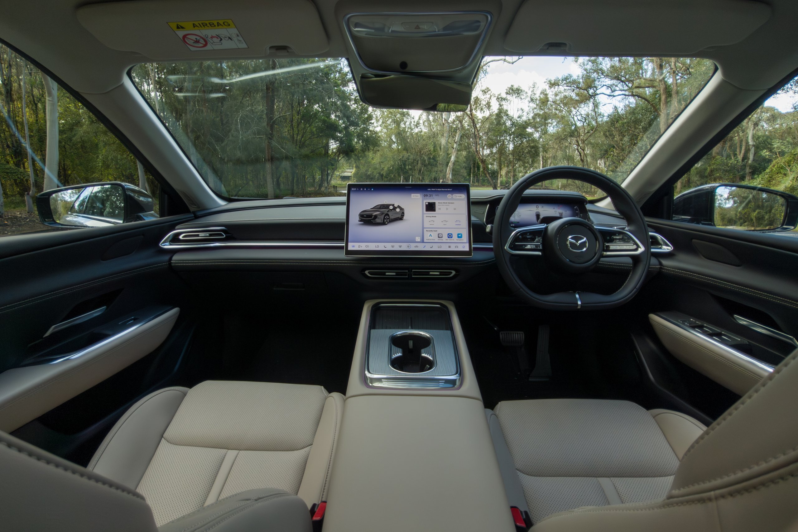 Dashboard of the 2026 Mazda 6e GT with centre touchscreen and beige front seats