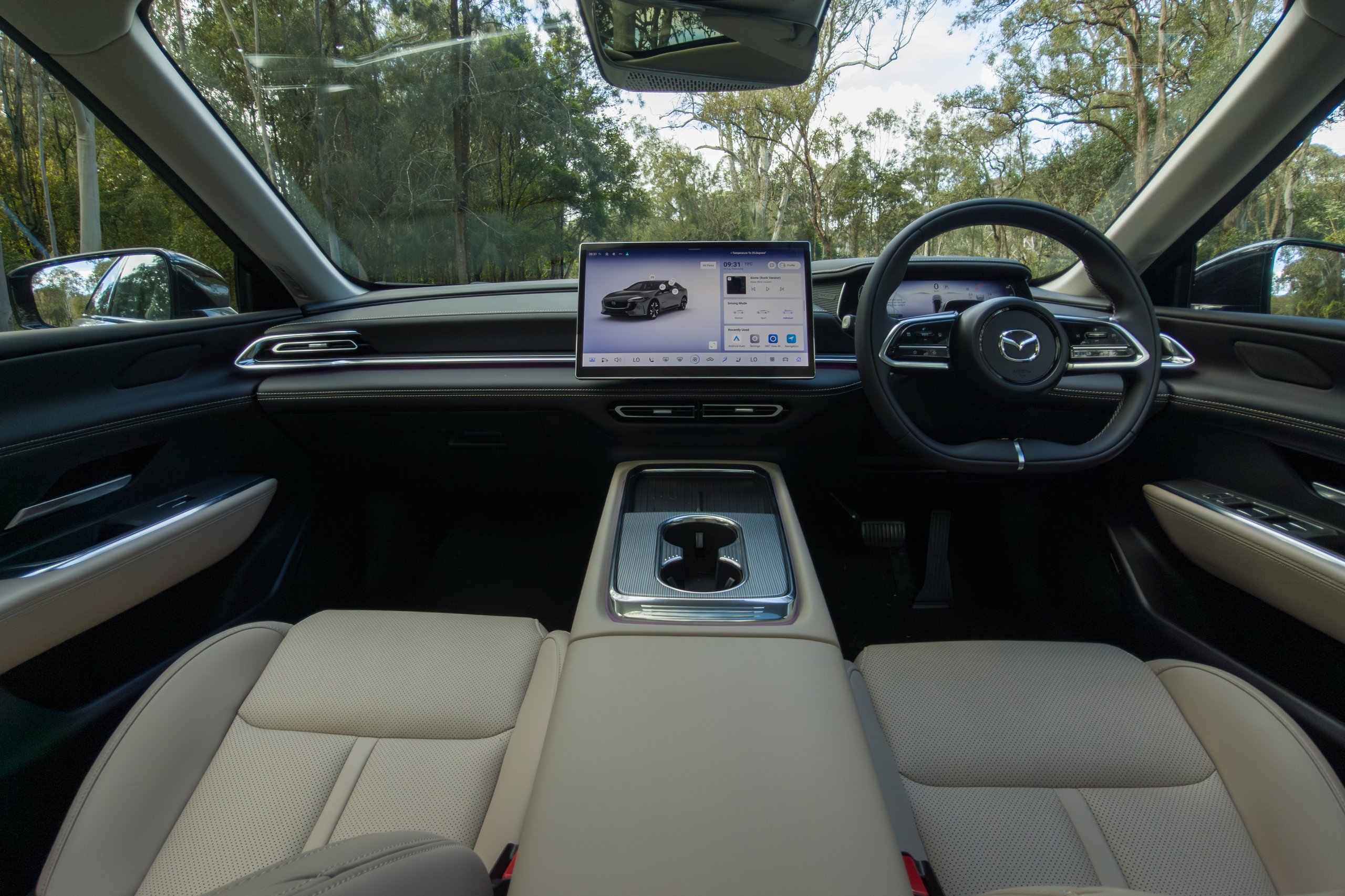 Front cabin of the 2026 Mazda 6e GT showing console, touchscreen and steering wheel