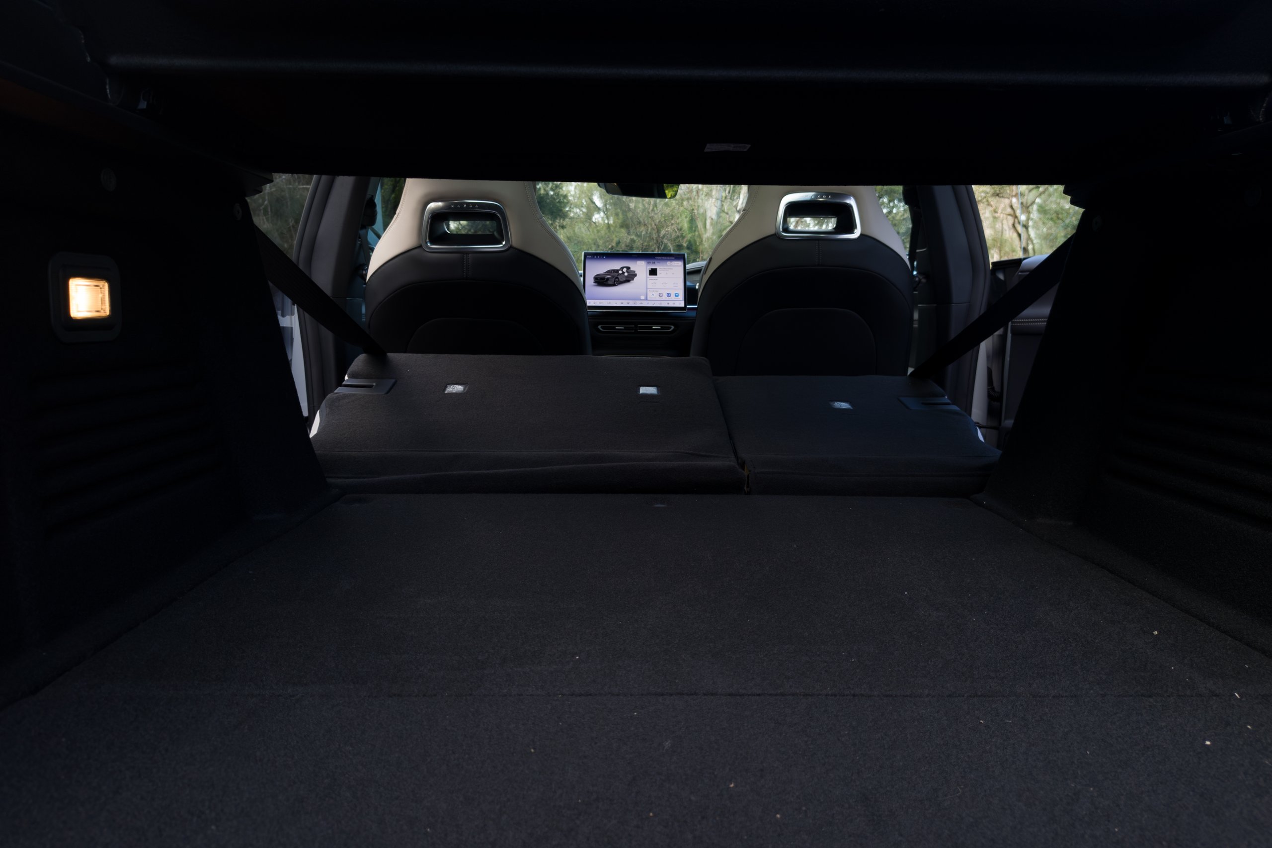 Both rear seats folded flat in the 2026 Mazda 6e GT viewed from the open boot