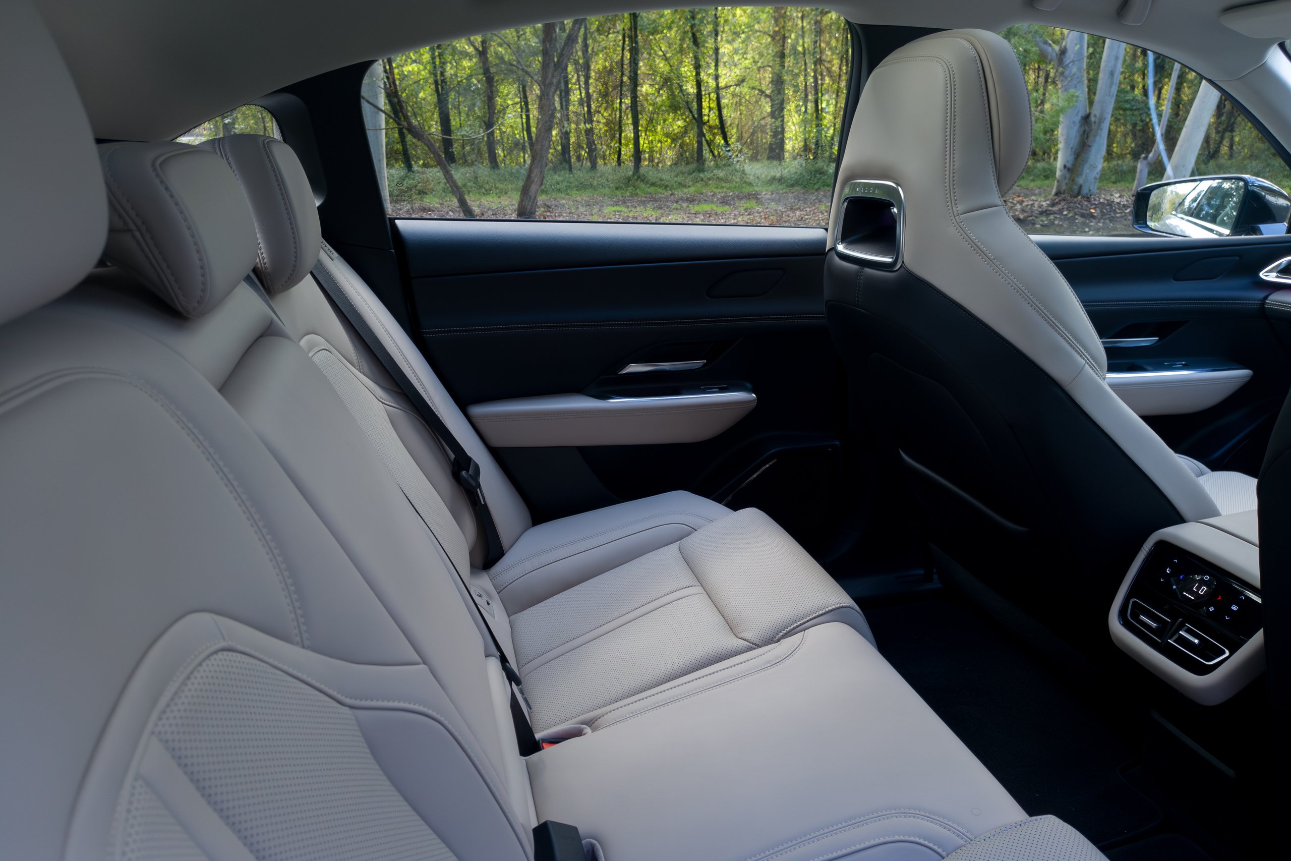 Rear bench seat of the 2026 Mazda 6e GT trimmed in perforated beige Maztex