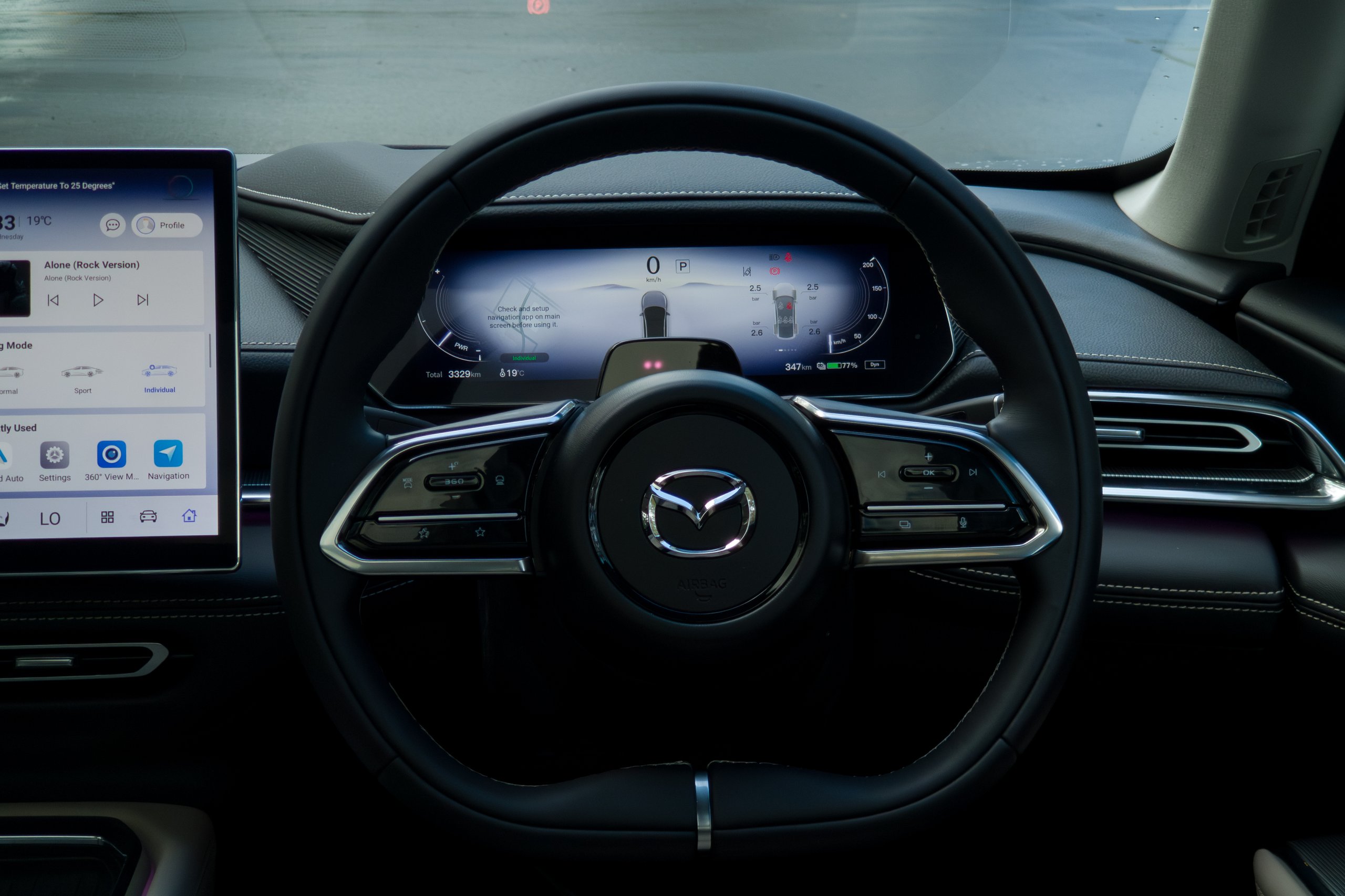 Leather steering wheel and digital driver display of the 2026 Mazda 6e GT