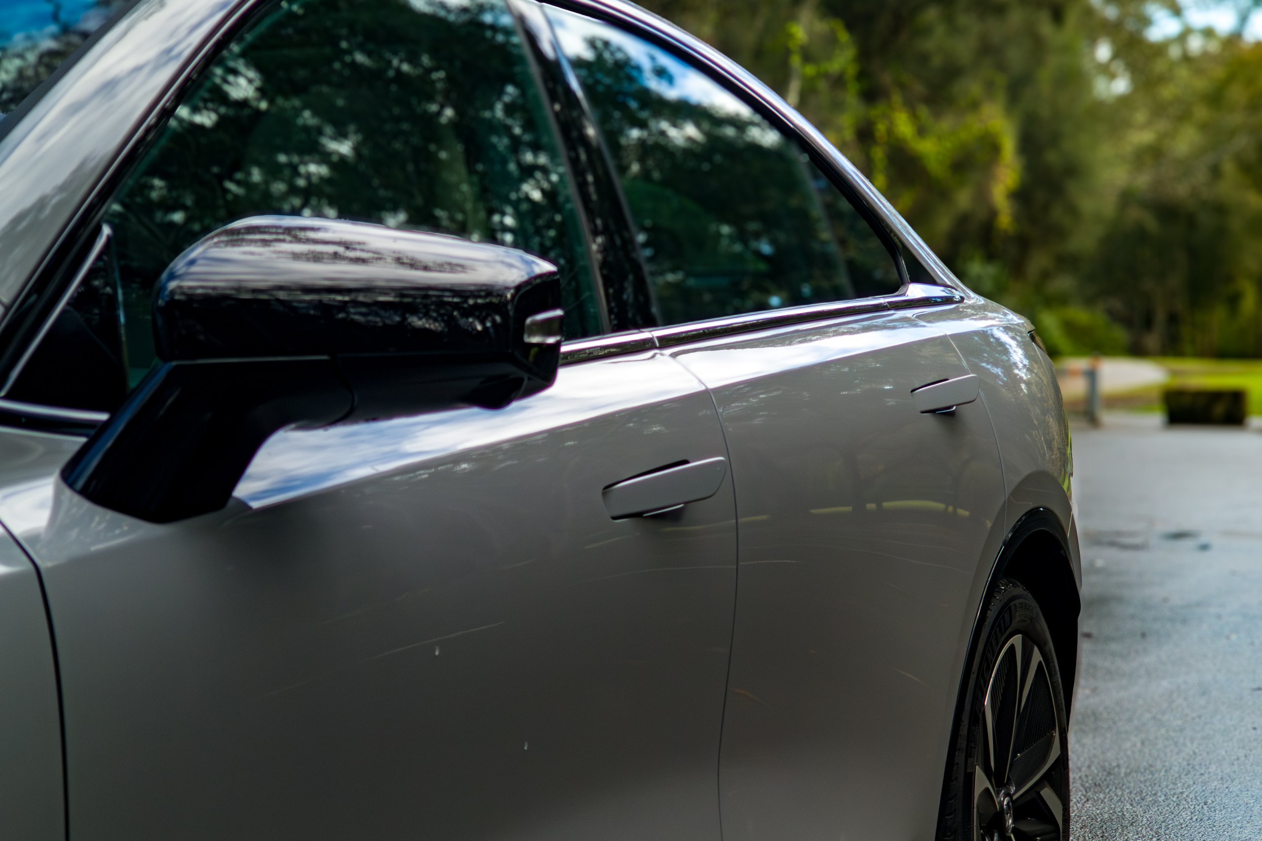 Close view of the gloss black wing mirror and flush door handles on the 2026 Mazda 6e GT