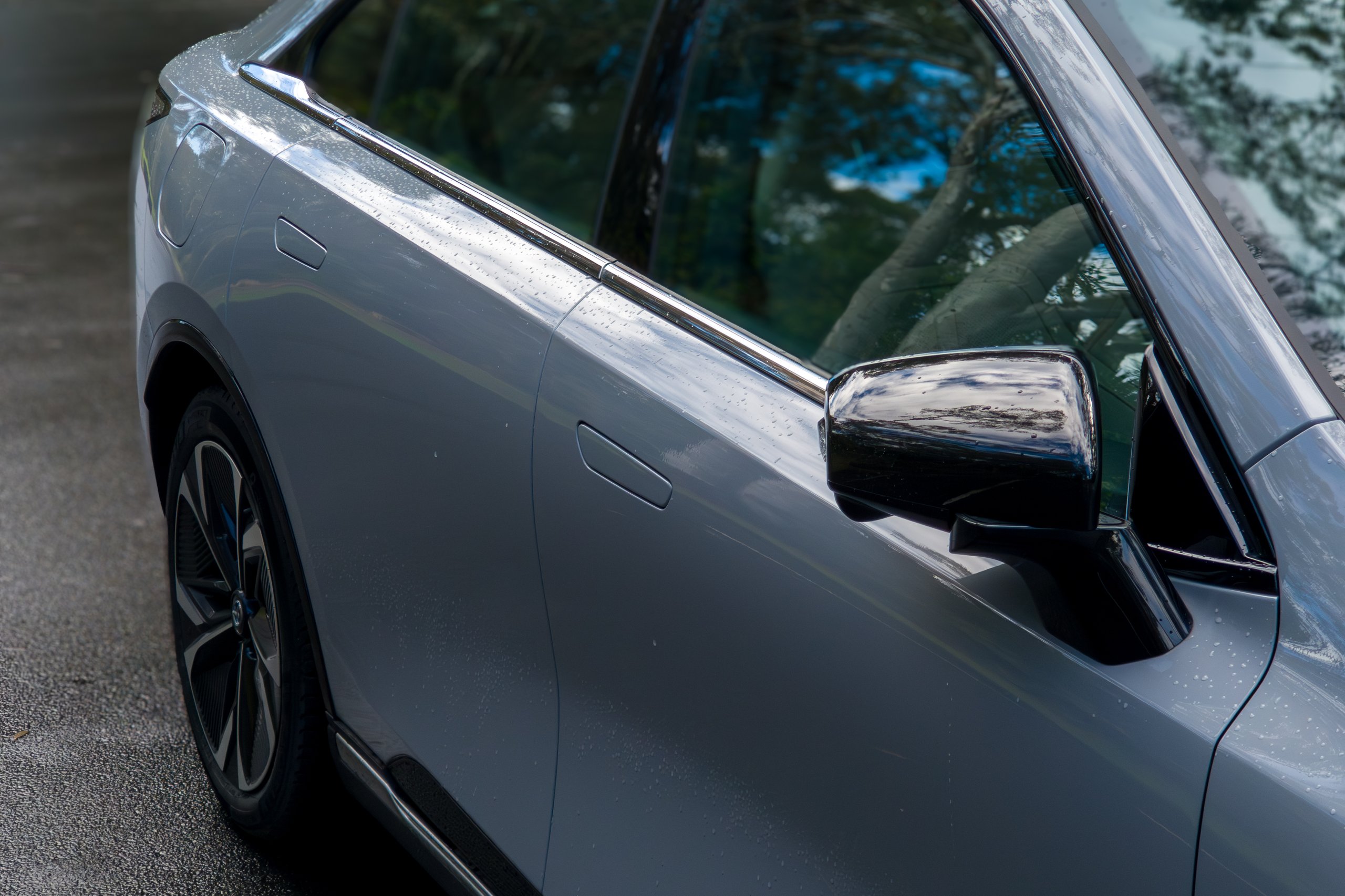 Gloss black driver-side wing mirror and chrome window trim on the 2026 Mazda 6e GT